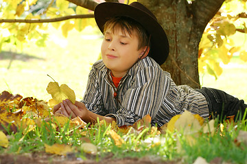 Image showing Child holding autumn leaves