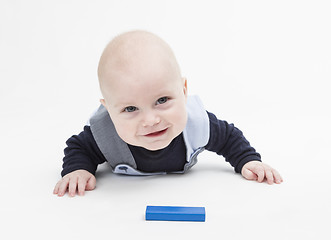 Image showing interested baby with toy block