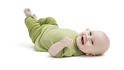 Image showing happy toddler lying on his back