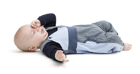 Image showing tired baby on floor isolated on white