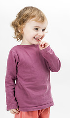 Image showing abashed young girl in light grey background