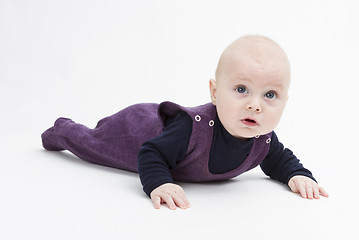 Image showing toddler in dark clothing crawling