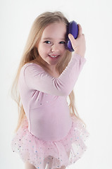 Image showing Little girl combing hair