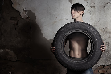 Image showing Man with tire