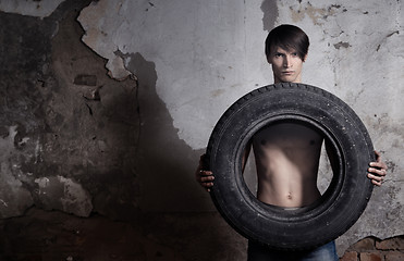 Image showing Man with tire