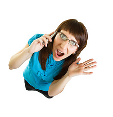 Image showing Girl with glasses emotionally speaks on the phone on white backg