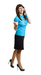 Image showing Smiling attractive girl talking on the phone on the move on a wh