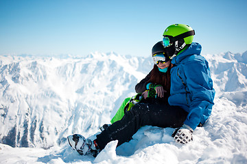 Image showing Young happy couple in snowy mountains.