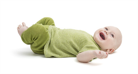 Image showing happy toddler laying on back