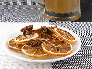 Image showing beer mug with cinnamon and lemon on white plate