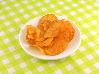 Image showing Potato chips falling in the white plate