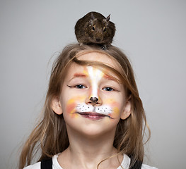 Image showing girl painted as a cat with grey mouse on the head