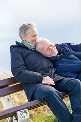 Image showing happy senior couple relaxing together in the sunshine