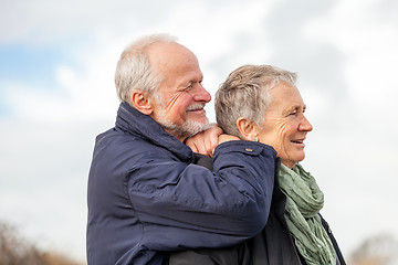 Image showing happy elderly senior couple walking on beach