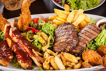 Image showing Platter of mixed meats, salad and French fries