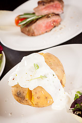 Image showing Baked jacket potato with sour cream sauce