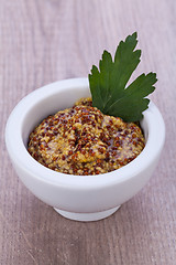 Image showing fresh yellow mustard in white bowl with parsley decorated