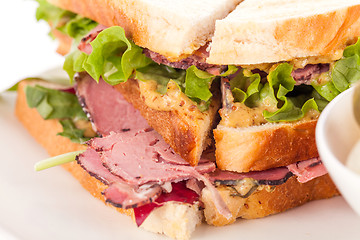 Image showing Delicious pastrami club sandwich and pickles