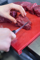 Image showing Chef or butcher dicing meat