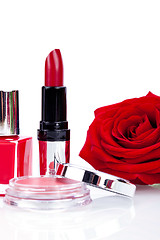 Image showing Fashionable cosmetics with a fresh red rose