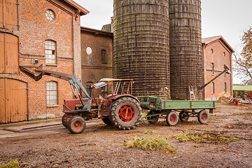 Image showing Tractor and trailer in a farmyard