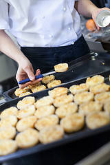 Image showing Chef preparing desserts removing them from moulds