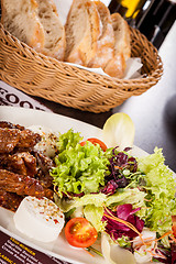 Image showing grilled beef stripes fresh salad and goat cheese