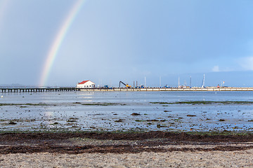 Image showing Rainbow over tidal mud flats at the coast