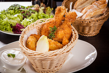 Image showing Crisp crunchy golden chicken legs and wings