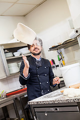 Image showing Chef tossing dough while making pastries