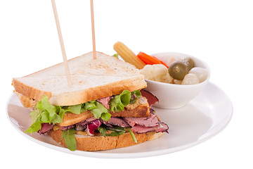 Image showing Delicious pastrami club sandwich and pickles