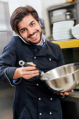 Image showing Chef taking a call on his smartphone