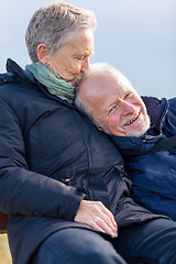 Image showing happy senior couple relaxing together in the sunshine