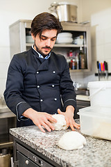 Image showing Chef tossing dough while making pastries
