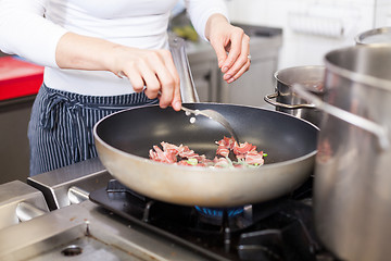 Image showing Chef or braising meat in a frying pan