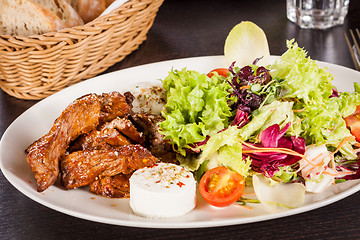 Image showing grilled beef stripes fresh salad and goat cheese