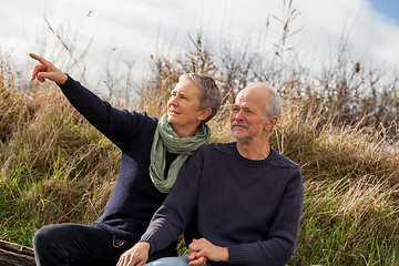 Image showing happy senior couple relaxing together in the sunshine