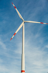 Image showing Wind turbine against a blue hazy sky