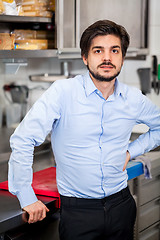 Image showing Friendly attractive man in a commercial kitchen