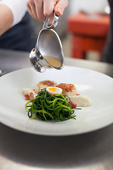 Image showing Delicious starter of stuffed savoury eggs and scallops