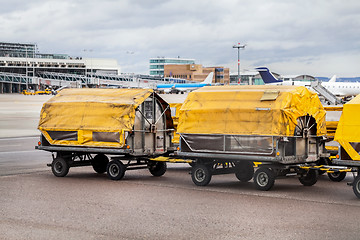 Image showing Trolleys loaded with luggage at an airport