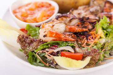 Image showing Grilled prawns with endive salad and jacket potato