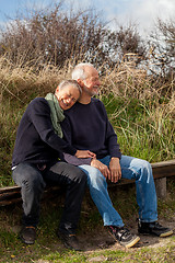 Image showing happy senior couple relaxing together in the sunshine