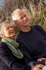 Image showing happy senior couple relaxing together in the sunshine