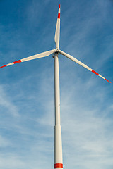 Image showing Wind turbine against a blue hazy sky