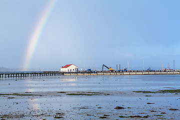 Image showing Rainbow over tidal mud flats at the coast