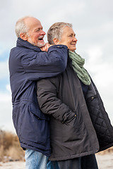 Image showing happy elderly senior couple walking on beach