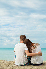 Image showing romantic young couple sitting on the beach in summer