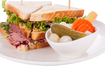 Image showing Delicious pastrami club sandwich and pickles