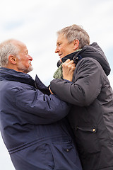 Image showing happy elderly senior couple walking on beach